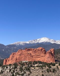 Pikes Peak covered with snow and rocks of Garden of the Gods